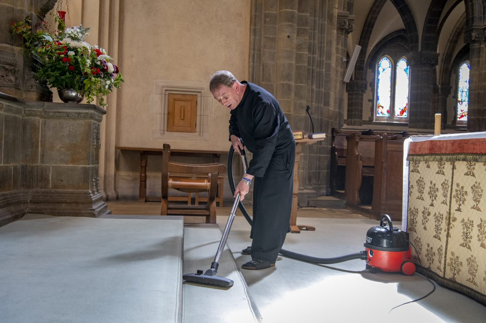 Fr Oswald hoovering the Abbey Church