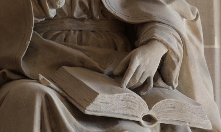 Statue of Our Lady with hand on Bible 