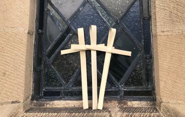 Palm Sunday crosses against stained glass window
