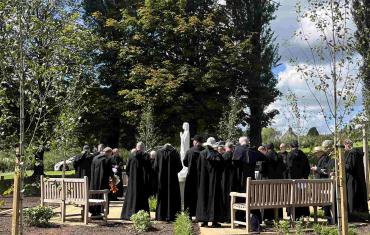 The monks praying around the Marian Garden